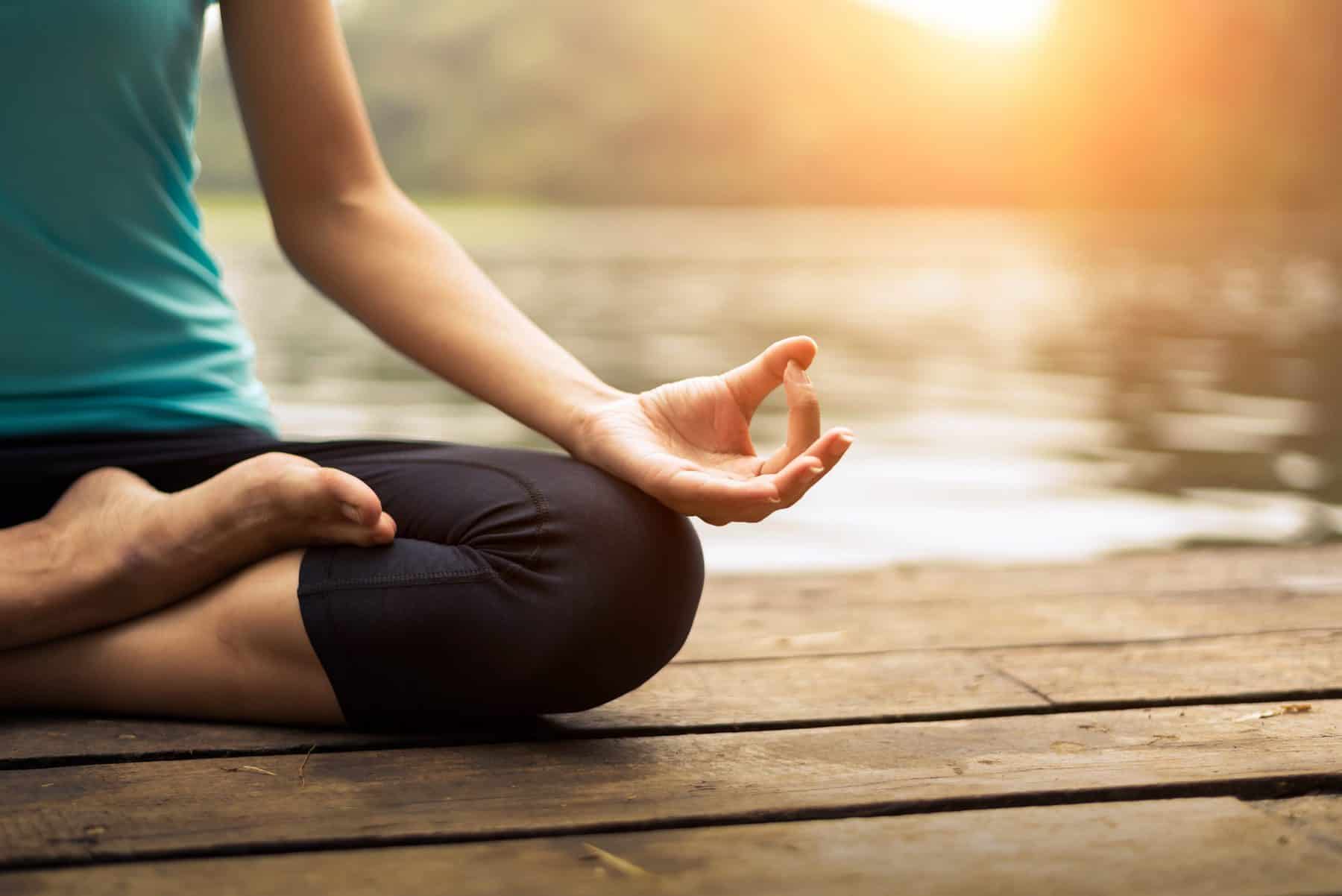 Close up hand. Woman do yoda outdoor. Woman exercising yoga at the nature background, select focus
